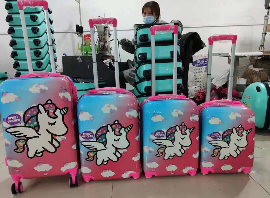Une grande valise rose avec une poignée de roue à rotor. Une valise légère pour les enfants.