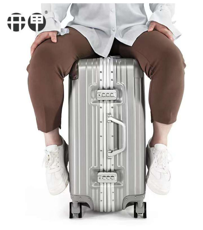Nouvelle dernière valise de voyage ABS+PC Universal roue fermeture à glissière chariot boîte de traction en cuir boîte code boîte bagages en gros